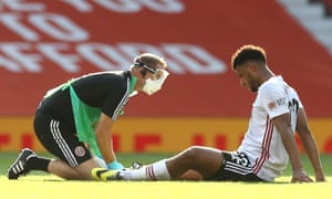 Lys Mousset of Sheffield United receives medical treatment from a member of the medical staff.