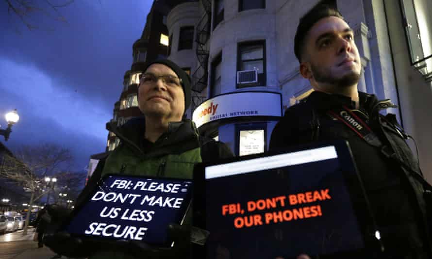 Demonstrators display iPads with messages against FBI’s proposals to weaken data security on their screens, outside an Apple store in Boston in February 2016.
