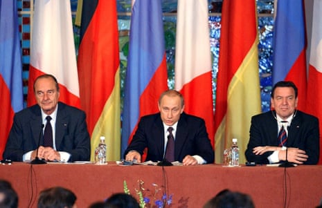 Russian President Vladimir Putin, center, addresses journalists during a joint press conference with French president Jacques Chirac and German chancellor Gerhard Schröder in St. Petersburg, Russia in 2003.