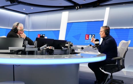 Keir Starmer sits opposite Nick Ferrari at a studio desk with both wearing headphones