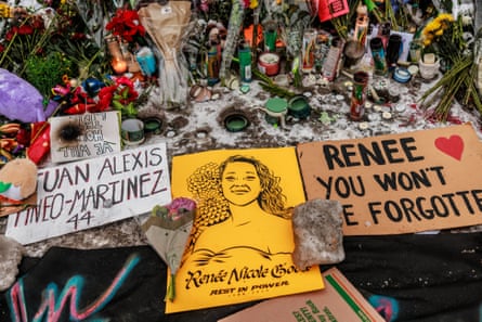 candles, flowers and signs including ‘renee you won’t be forgotten’ and ‘we will hold the line’ at a memorial site outside