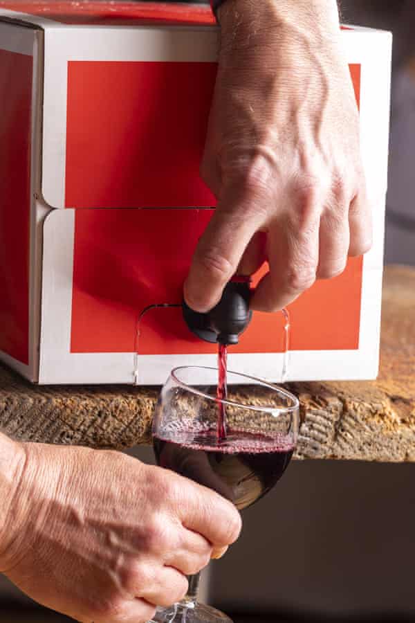 Pouring red wine from a box