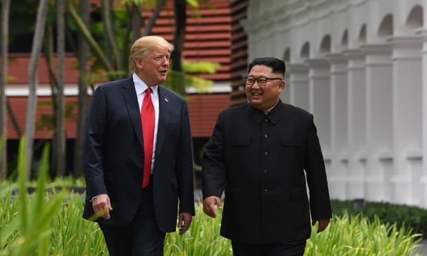 Kim Jong-un walks with Donald Trump during a break in talks.