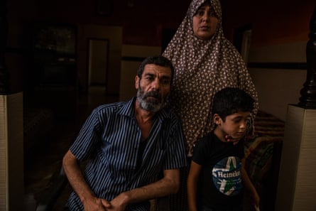 A father, mother and their young son at home