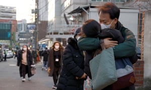 A parent hugs their child before taking the annual college entrance exams amid the coronavirus pandemic outside an examination room in Seoul, South Korea, December 3, 2020.