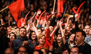 Supporters of Vetëvendosje wave Albanian national flags during the party’s closing election campaign rally in Pristina.