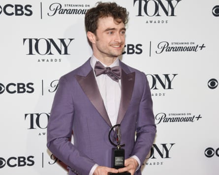 Daniel Radcliffe successful purple overgarment pinch front necktie holding award