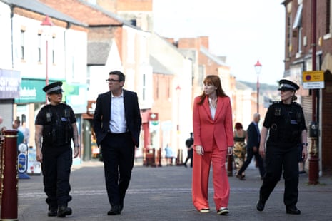 Andy Burnham and Angela Rayner walking past shops in the town centre of Ilkeston, Derbyshire.