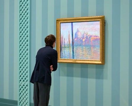 A visitor looks over Monet’s 1908 painting Le Grand Canal.