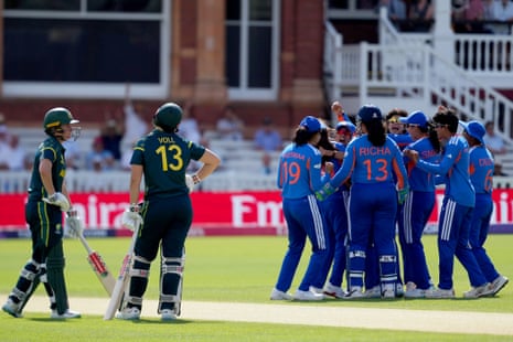 The Indian players celebrate the wicket of Georgia Voll