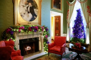 A tree of purple ornaments and natural orchids decorates the Green Room.