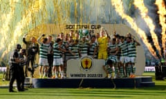 Callum McGregor lifts the trophy with his teammates at Hampden Park.