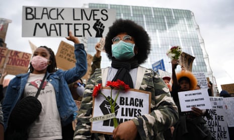 People take part in a Black Lives Matter protest outside the US Embassy in London on 7 June.
