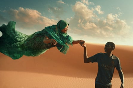 A man leads a flying woman through a desert