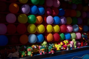 California, US. A selves of brightly coloured balloons or balls above a row of equally bright stuffed toys