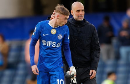 Pep Guardiola talks to Cole Palmer aft Manchester City’s victory.