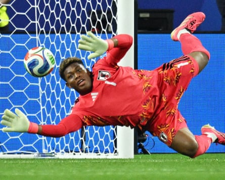 The Japan goalkeeper Zion Suzuki dives to his right to make a save during his team’s 2026 men’s World Cup group stage game against Sweden in Arlington, Texas.