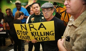 A protester holds a sign that reads, ‘NRA Stop Killing Our Kids’, outside the court-room where Nikolas Cruz, 19, a former student at Marjory Stoneman Douglas High School in Parkland, Florida, was having a bond hearing.