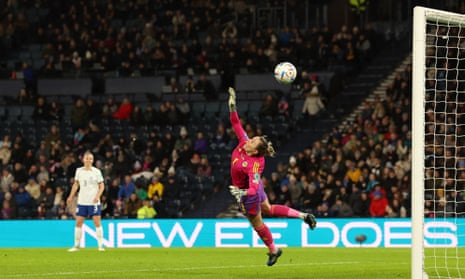 Scotland goalkeeper Lee Gibson dives for the ball as Lauren James of England (out of frame) scores their team's third goal.