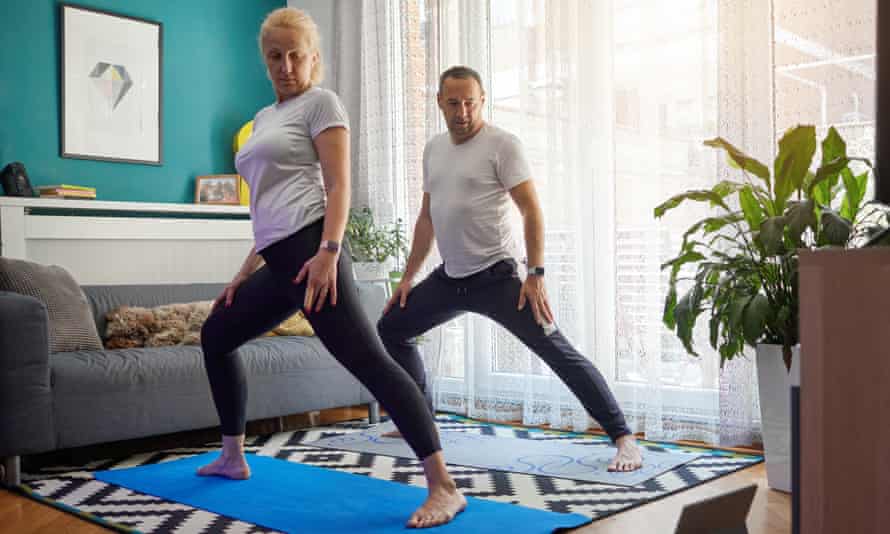 Couple practising yoga at home