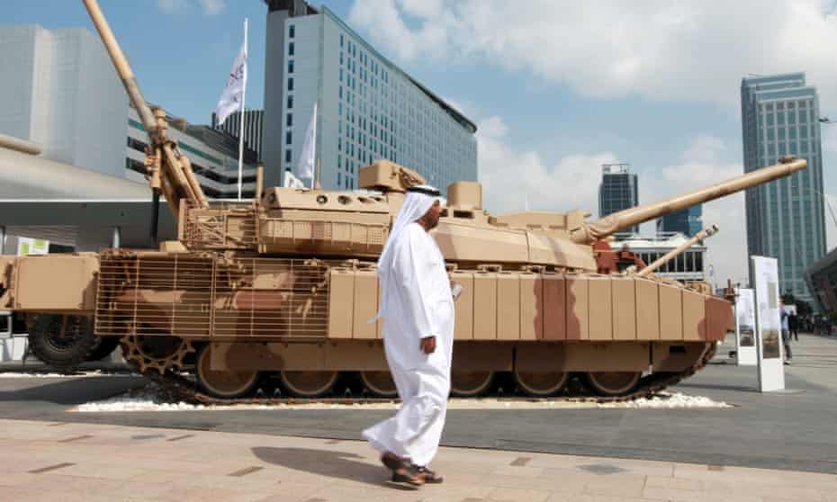 A visitor walks past a battle tank at the International Defence Exhibition in Abu Dhabi