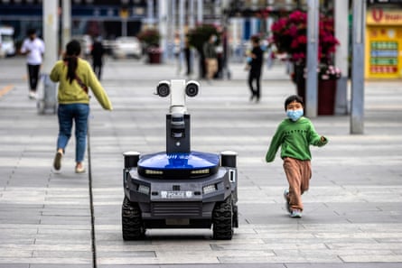 A police security robot near the high-speed railway station in Shenzhen, China, in March 2020. The machines warn people if they are not wearing masks, and check body temperature and identity.