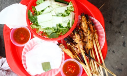 Close-up image of thịt nướng: grilled pork, chicken or prawns that come with some herbs and greens.