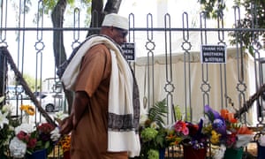A man walks past flowers laid outside the Al Noor mosque on the first anniversary of the Christchurch shooting
