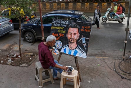 An artist draws a painting of Lionel Messi, in Mumbai