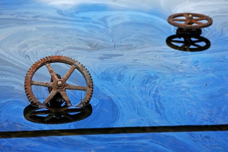Rusted wheels in oily water