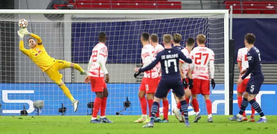 Peter Gulacsi of RB Leipzig makes a save from Kevin De Bruyne of Manchester City.