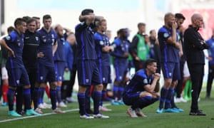 Finland players wait as Denmark’s Christian Eriksen receives medical attention after collapsing.