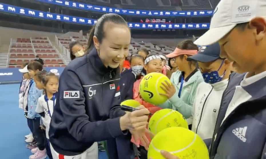 Peng Shuai signs tennis balls in a video released on Sunday