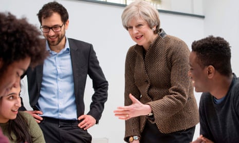 Theresa May speaks with headteacher Dan Abramson, left, and students at King’s College London Mathematics school, a free school.