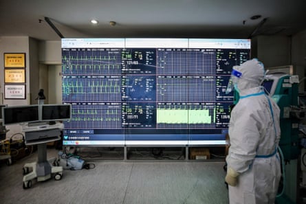 A medical staff member monitors a screen that shows figures of patients infected by the Covid-19 coronavirus at a Red Cross hospital in Wuhan.