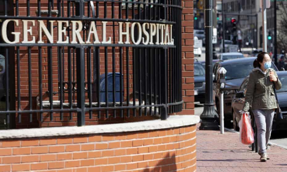 A woman wears a mask outside Massachusetts General Hospital in Boston on Saturday.
