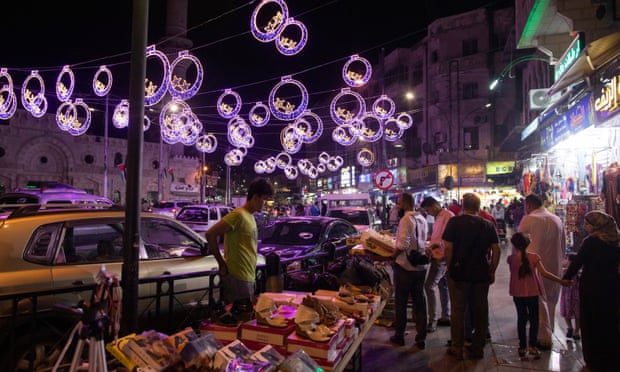 Jordanians shop before Eid al-Fitr in Amman.