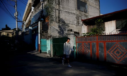 Oliver Emocling, 23, who works for a magazine, leaves his neighbourhood in Caloocan city