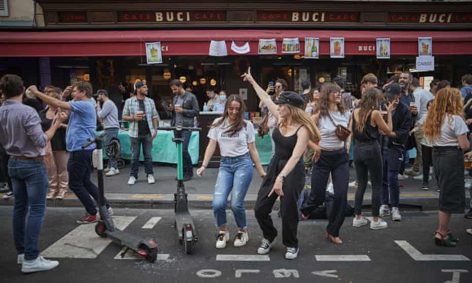 Young Parisians dance in the street at a bar in the 6th Arrondissement as Paris celebrates the first day of summer