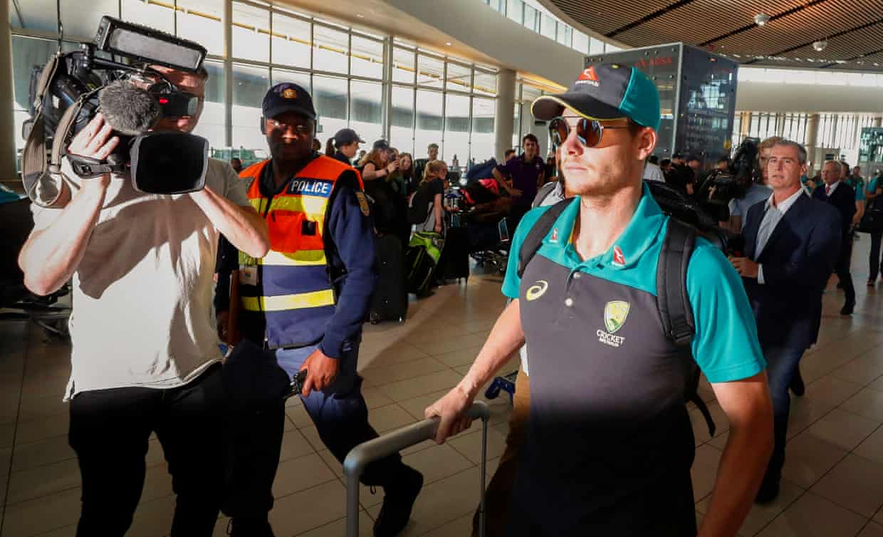 Steve Smith departs from Cape Town flanked by security and media after the series.