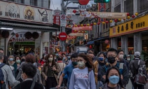 People wear protective face masks while shopping for Lunar New Year goods on January 27, 2022 in Taipei, Taiwan.