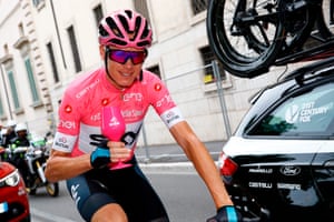 Christopher Froome holds a glass of sparkling wine during the start of the 21st and last stage of the 101st Giro d’Italia.