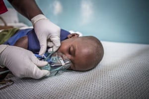 Save the Children emergency health officer Jedidah Onyango fits an oxygen mask to three year-old pneumonia patient Jackson at Turkana County referral hospital, Kenya.