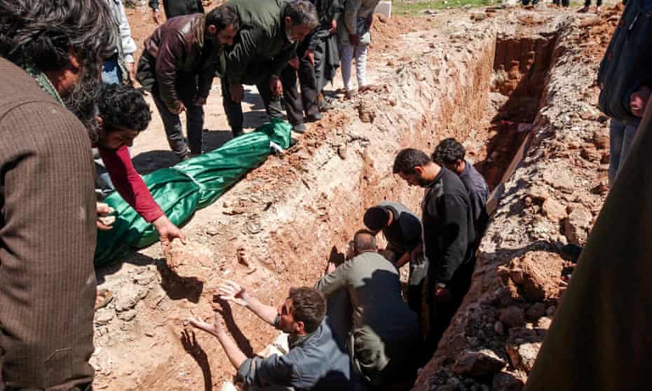 Syrians dig a grave to bury the bodies of victims of a chemical attack in Khan Sheikhun, in Idlib. 