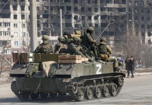 Service members of pro-Russian troops are seen atop of an armoured vehicle with the symbol Z painted on its side in the besieged southern port city of Mariupol, Ukraine.