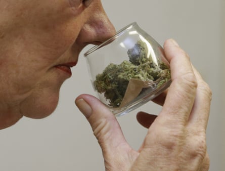 A customer checks the aroma of a jar of medicinal marijuana at a dispensary in Sacramento.