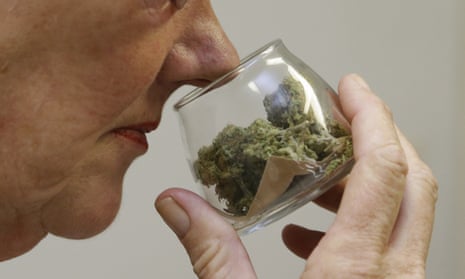 A customer checks the aroma of a jar of medicinal marijuana at Canna Care, a medical marijuana dispensary in Sacramento.