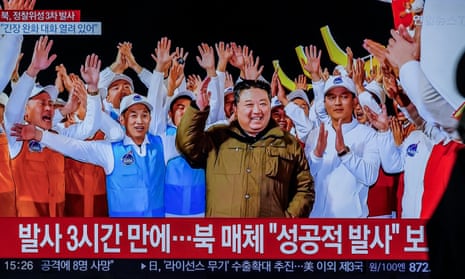 A TV at Seoul’s Yongsan station shows Kim Jong-un celebrate the launch of North Korea’s reconnaissance satellite entering orbit. 