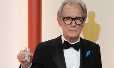 Bill Nighy with the stained Babblebrook family Sylvanian rabbit belonging to one of his granddaughters at the Oscars ceremony.
