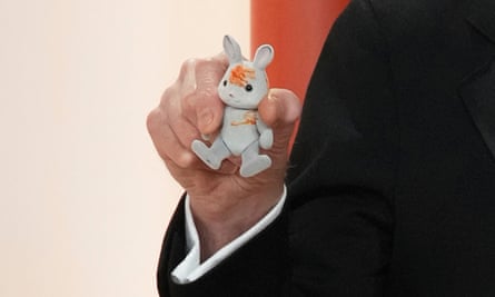Bill Nighy, with a small stuffed rabbit, arrives at the Oscars on Sunday, March 12, 2023, at the Dolby Theatre in Los Angeles. (Photo by Jordan Strauss/Invision/AP)